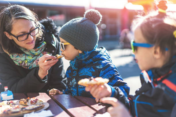 istock Family eating pizza in the park 1132477267
