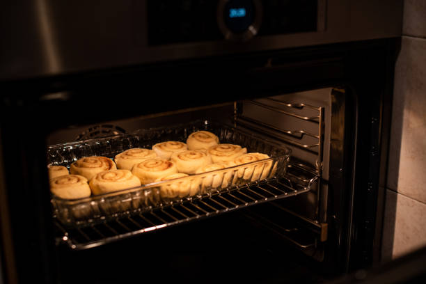 istock homemade cinnamon rolls, baking in the owen 1132480620