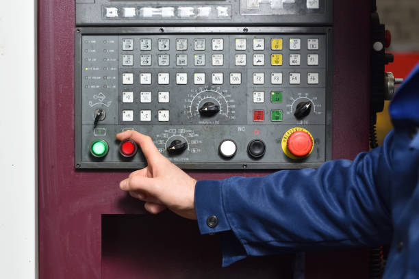 istock Worker in blue workwear holds hands on the control panel of the CNC machine. Close-up 1132480802