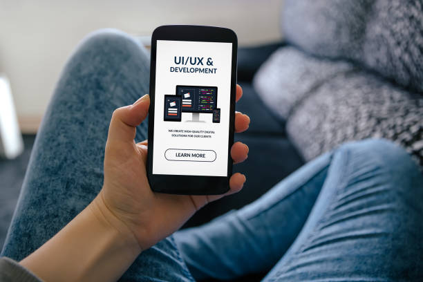 istock Girl holding smart phone with UI/UX design and development concept on screen 1132482517