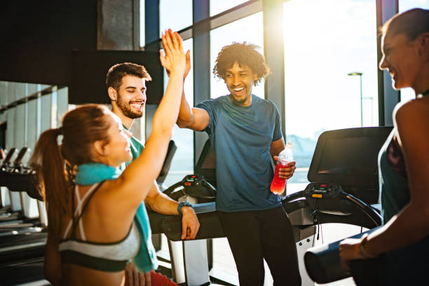 Sporty couple giving high five to each other at gym stock photo