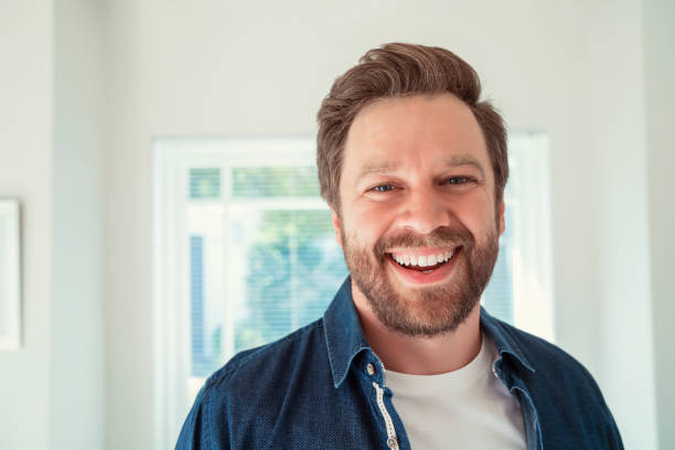 Close-up portrait of happy mid adult man at home Close-up of joyful mid adult male wearing casuals. Portrait of happy man is having beard. He is in living room. 35 39 years stock pictures, royalty-free photos & images