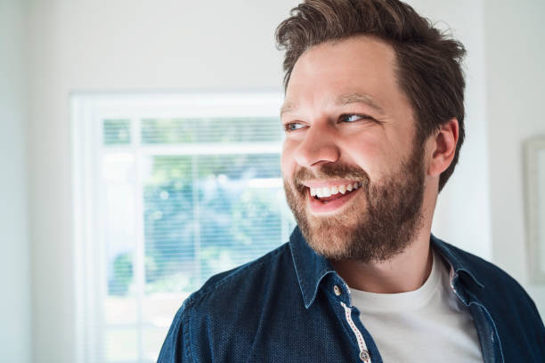 istock Thoughtful smiling man looking away at home 1132483918