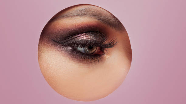 istock Bright eye makeup. Smokey eyes, colored eyeshadow. round cutout in paper. 1132485594