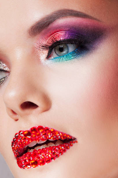 istock Bright eye makeup and red lips in rhinestones. Pink and blue color, colored eyeshadow. 1132485653