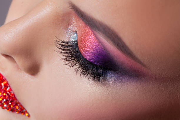 istock Bright eye makeup and red lips in rhinestones. Pink and blue color, colored eyeshadow. 1132485655