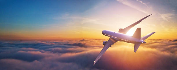 Passengers commercial airplane flying above clouds