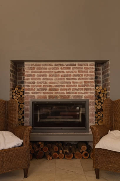istock Fireplace in living room at home with chairs 1132487411