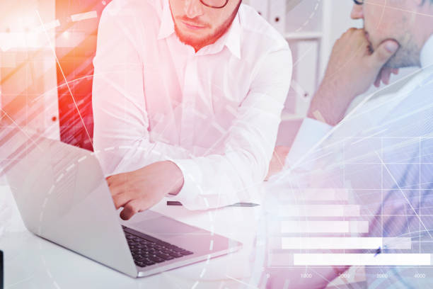 istock Businessmen with laptop in office, graph 1132487948