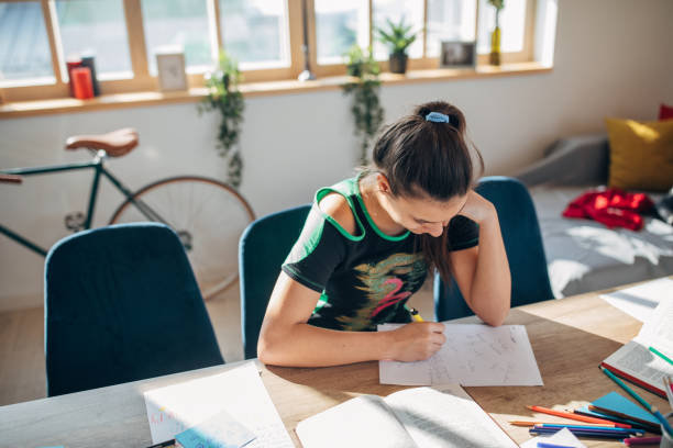 istock Young girl student studying alone on class in private school 1132488165