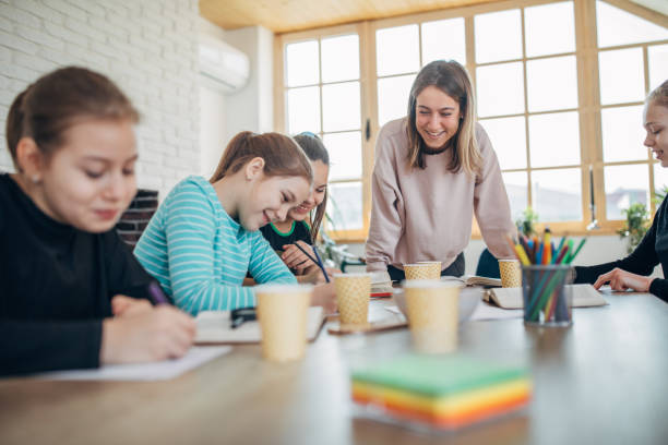 istock Young lady teacher and girls students on private class 1132488248