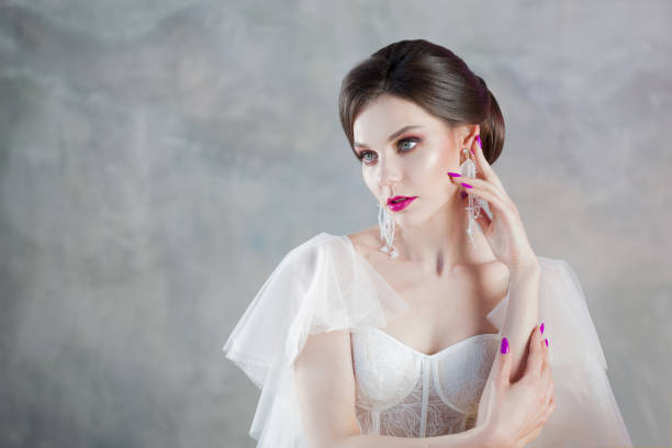 istock Beautiful and stylish bride in wedding dress in Studio on grey 1132489333