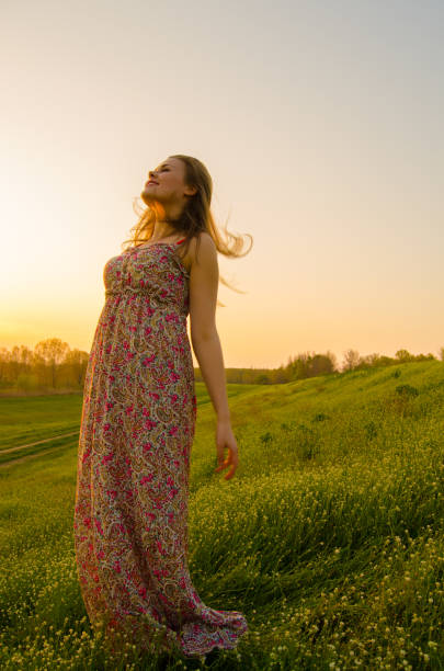 istock Young woman standing on the summer meadow 1132490743