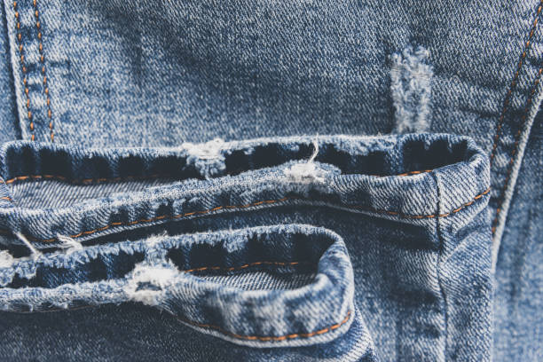 istock Denim blue jeans texture with scuffs and holes. Abstract background. 1132492290