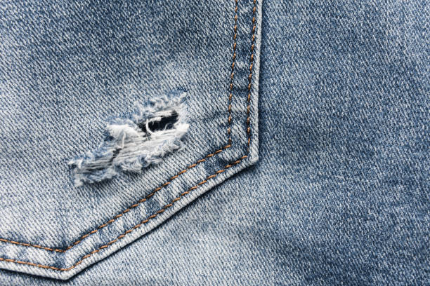 istock Denim blue jeans texture with scuffs and holes. Abstract background. 1132492306