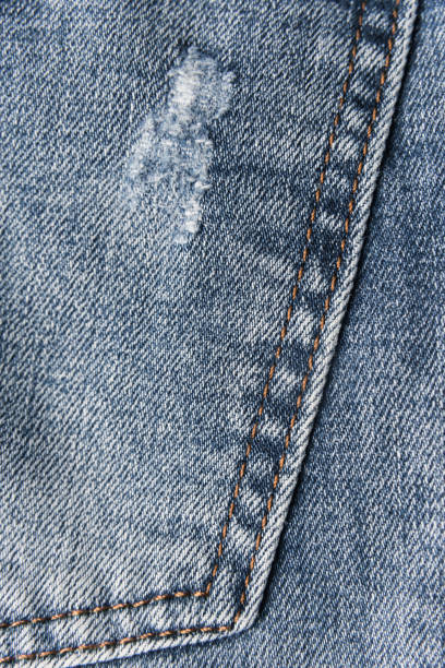 istock Denim blue jeans texture with scuffs and holes. Abstract background. 1132492315