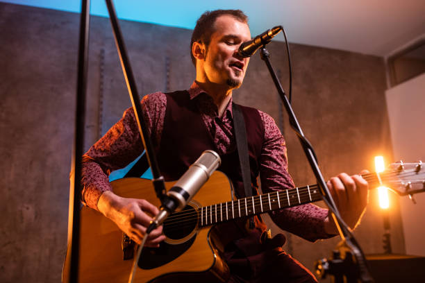 istock Pop musician singing and playing guitar 1132492623
