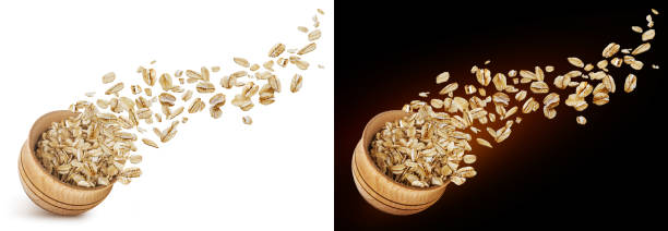 oat flakes flying out of wooden bowl isolated on white and black background - oatmeal rolled oats oat raw imagens e fotografias de stock