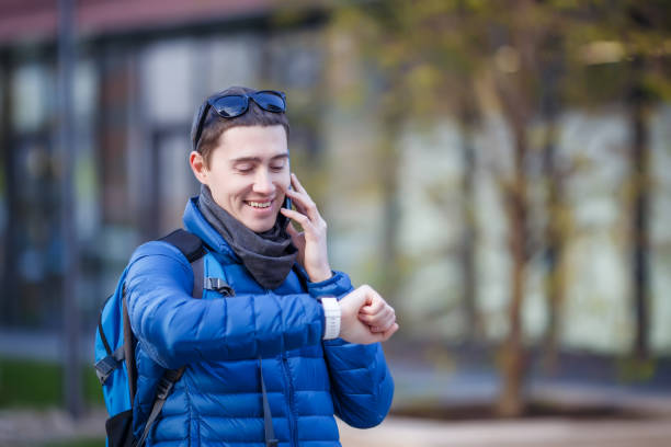 istock Man talking on phone and looking at smartwatch 1132493841
