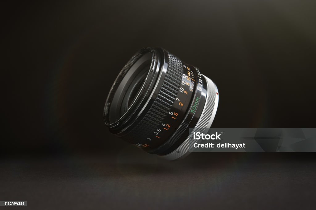 DSLR camera lens floating in the air Camera - Photographic Equipment Stock Photo