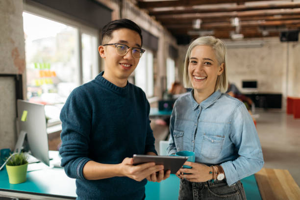 istock Friends from college working together 1132494435