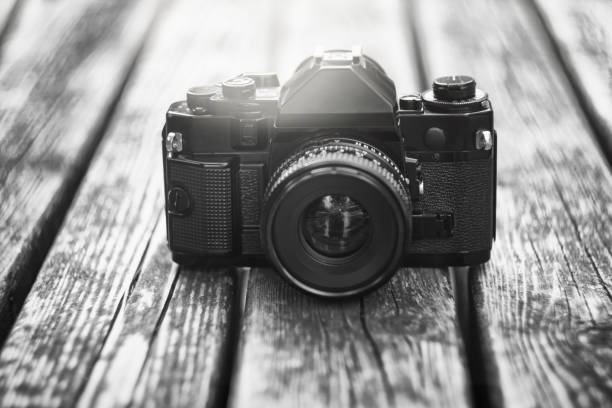 istock Retro single-lens reflex professional film camera on wooden table 1132494490
