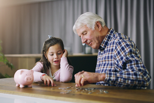 Carefree grandparents spending leisure time with grandson at home