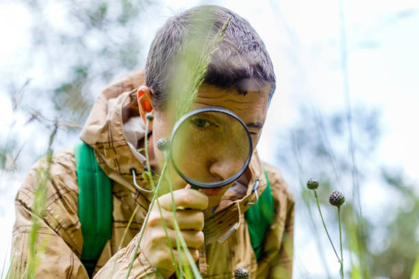 istock Picture of environmentalist man with magnifying glass 1132495819