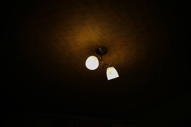 istock Lamps lighting on the ceiling in the dark room. indoor interior design. 1132496021