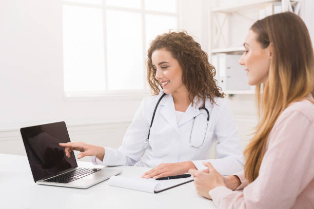Doctor using laptop and electronic medical record system