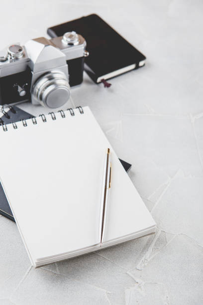 istock Retro photo camera with white note book on a stylish wooden background 1132501752
