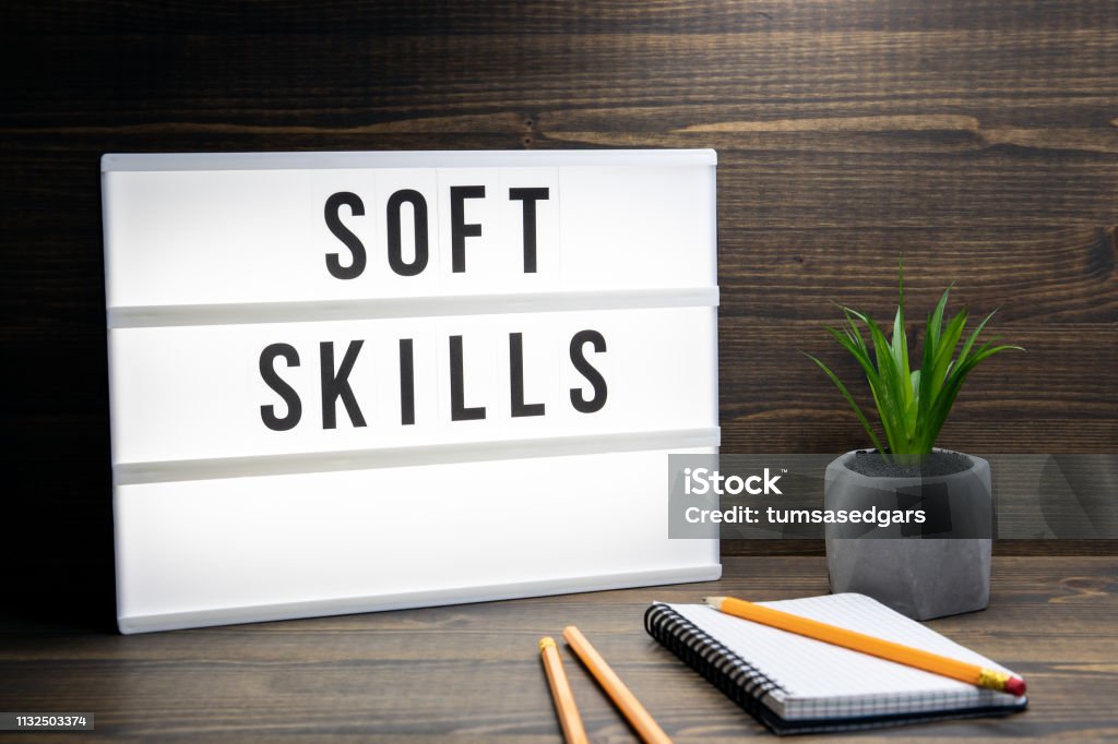 Soft Skills concept. Text in lightbox Soft Skills concept. Text in lightbox. Wooden office table Skill Stock Photo