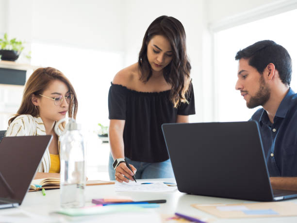 istock Latin young colleagues working together 1132503476