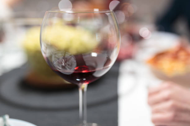 istock A glass of wine on a table that is set for dinner 1132504546