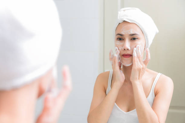 istock Woman Applying Face Wash In Bathroom 1132504570