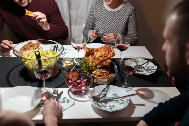 istock Friends enjoying and eating dinner 1132504626