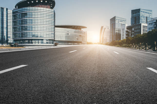 istock Asphalt pavement and modern architecture of city highway 1132505766