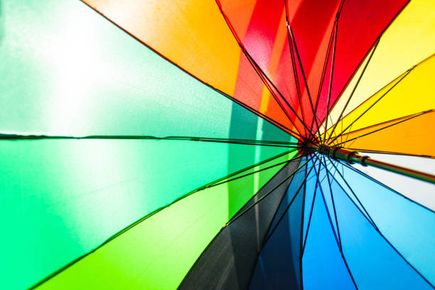 istock bright colorful rainbow umbrella under the sun, background 1132511464