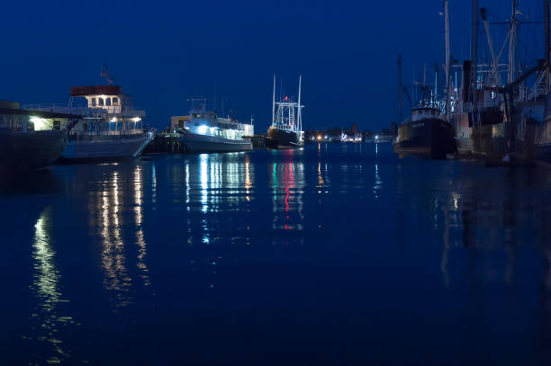 New Bedford, Massachusetts, USA - May 30, 2007: Bright lights reflecting across water at twilight along New Bedford waterfront
