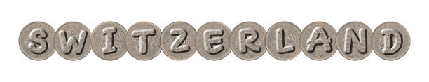 istock SWITZERLAND  word with Five New Pence Coins on White Background 1132513023
