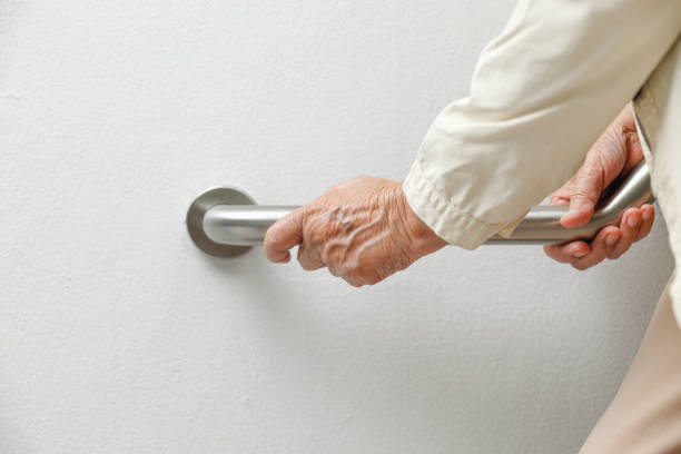 istock Elderly woman holding on handrail for safety walk steps 1132514305