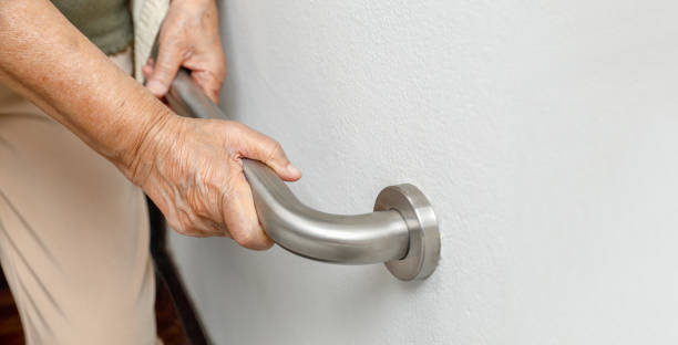 istock Elderly woman holding on handrail for safety walk steps 1132514367