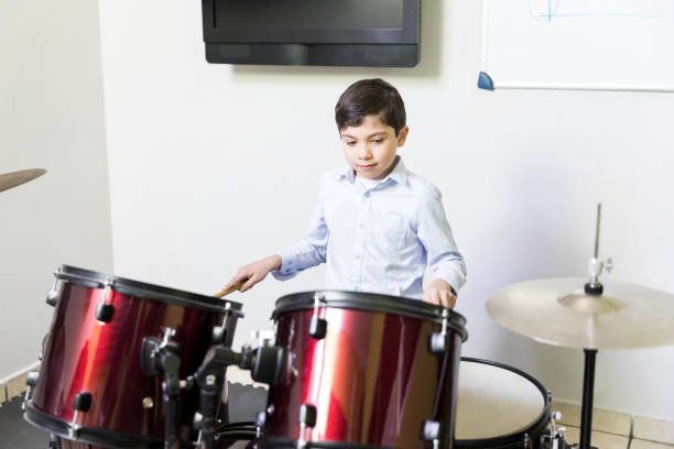 istock Boy Playing Percussion Instrument In Music Session 1132514693
