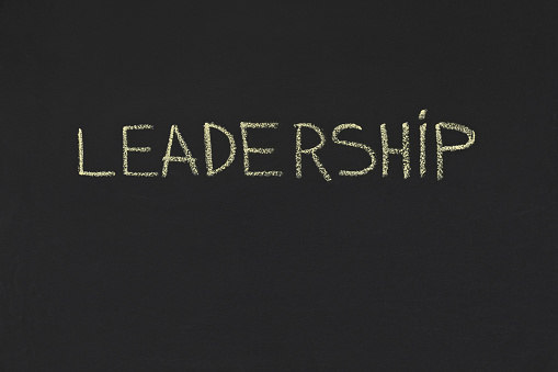 Leadership word in yellow chalk handwriting on blackboard, copy space