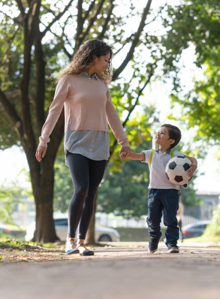 istock Happy mother picking up her son from school 1132516095