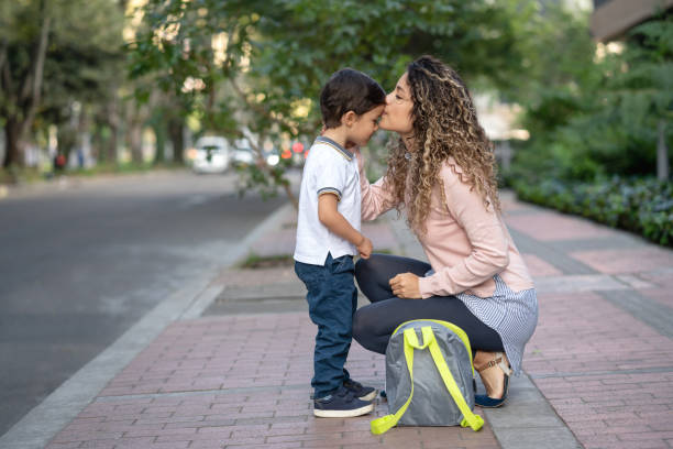 istock Mother kissing her son goodbye while taking him to school 1132516096