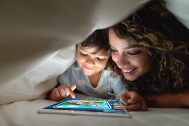 istock Mother and son in bed playing games on a tablet computer 1132516256