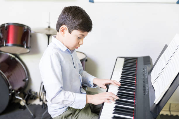 istock Student Practicing On Electric Instrument In Music School 1132516641