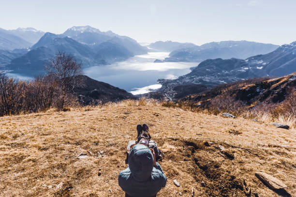 istock Hiker relaxing over mountain, lake in background 1132518845