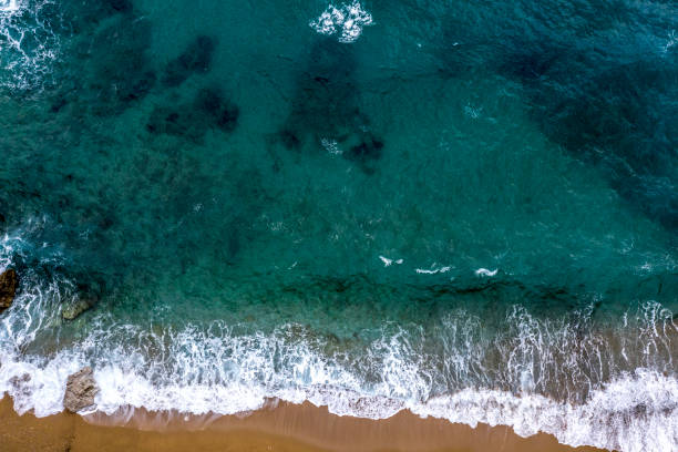 istock Waves of turquoise-colored sea breaking on the beach shore 1132519000